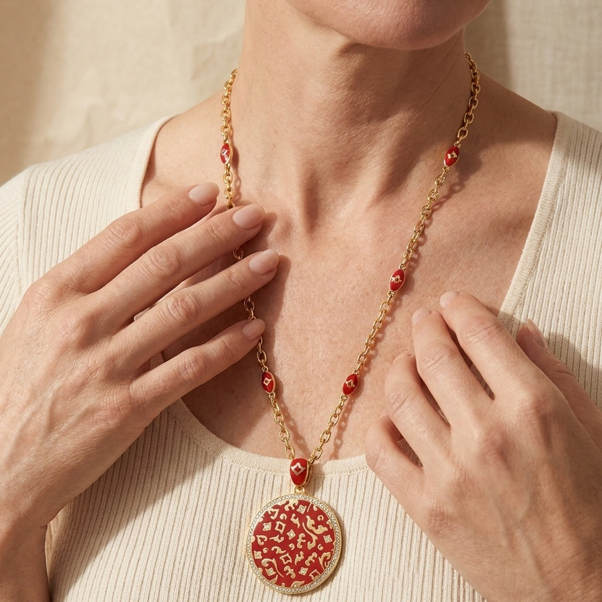 Fleur de Love pendant necklace with gold chain, red enamel beads, and round red filigree pendant on Tampa Home & Garden Store