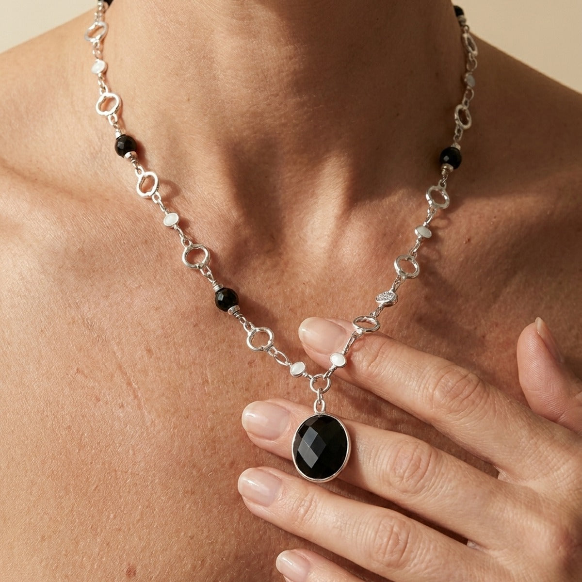 Dragon Lady Necklace pendant on silver chain with black faceted stone and white beads on Tampa Home & Garden Store