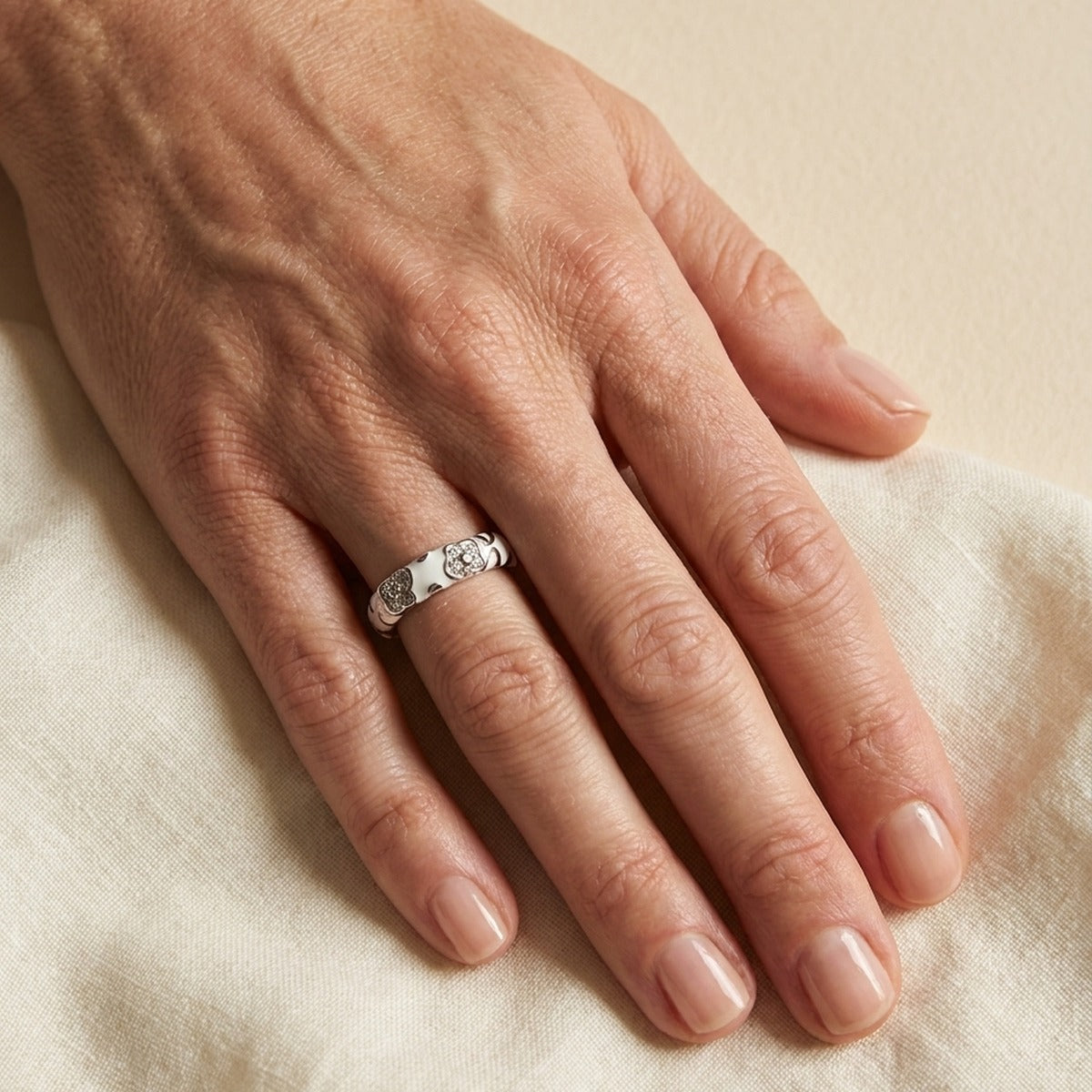 Flowers By Orly stackable ring in silver with floral motifs on finger on Tampa Home & Garden Store