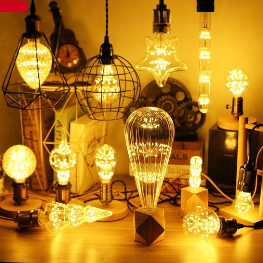 Stevvex LED Edison bulb set with warm filament bulbs in star and globe shapes on a desk on Tampa Home & Garden Store