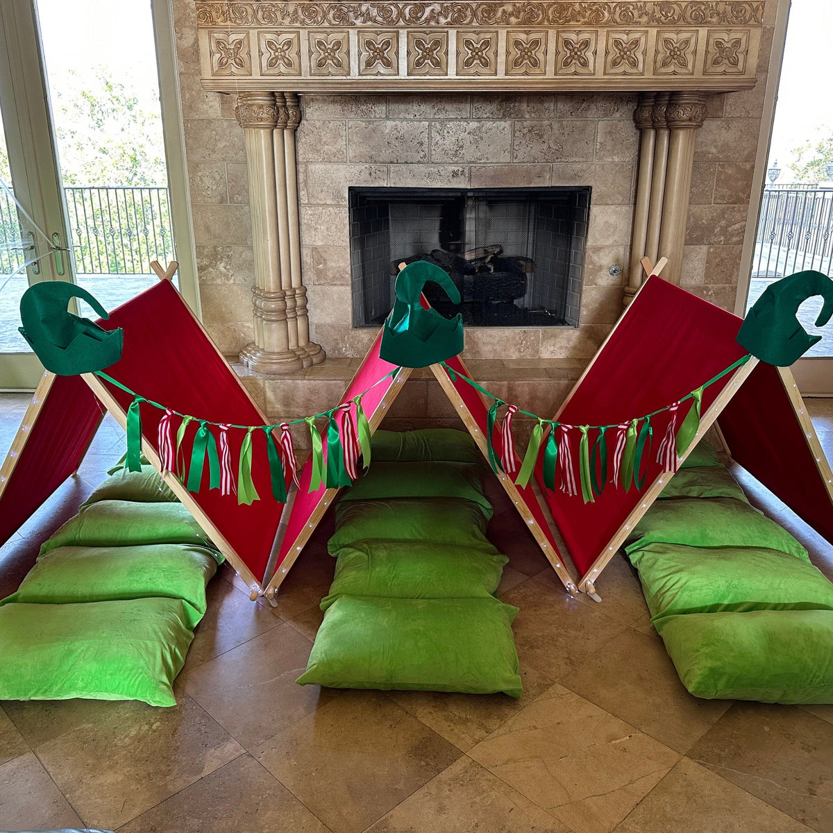 Little Elf Sleepover Set play tents with red panels and green cushions by fireplace on Tampa Home & Garden Store