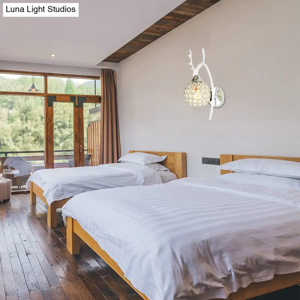 Decorbites chrome deer wall sconce with crystal dome 1-2 light above twin beds in a bedroom on Tampa Home & Garden Store