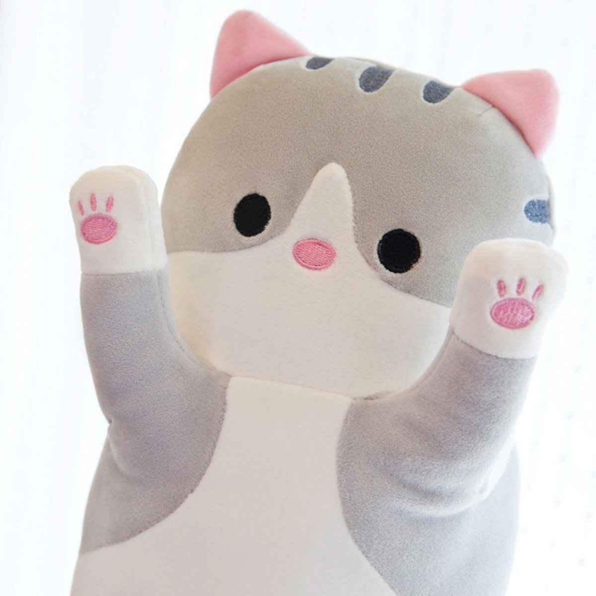 Long cat plush pillow in gray and white with pink ears and paw pads raised paws on Tampa Home & Garden Store