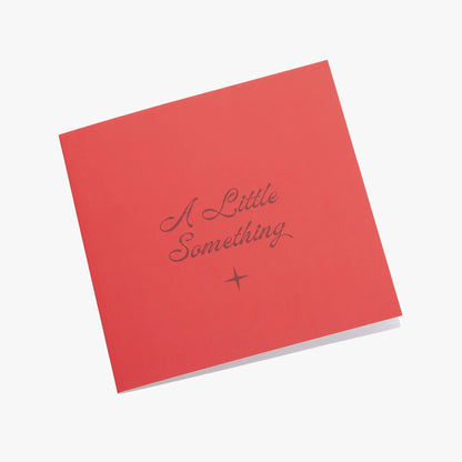Love Greeting Card red card with cursive A Little Something and tiny star accent on Tampa Home & Garden Store