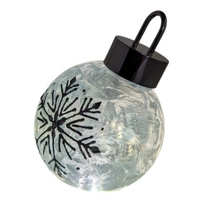 Frosted blue-green lighted snowflake glass ornament with black cap and hanging loop on Tampa Home & Garden Store