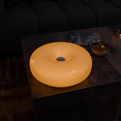 Lumo Donut Glass LED table lamp yellow donut-shaped glass shade on marble coffee table on Tampa Home & Garden Store