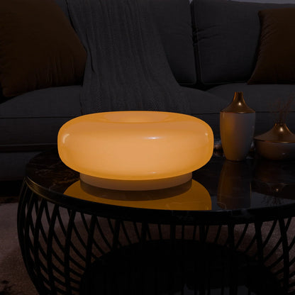 Lumo Donut Glass LED table lamp by Moktan Sabai, amber donut lamp atop a glass coffee table on Tampa Home & Garden Store