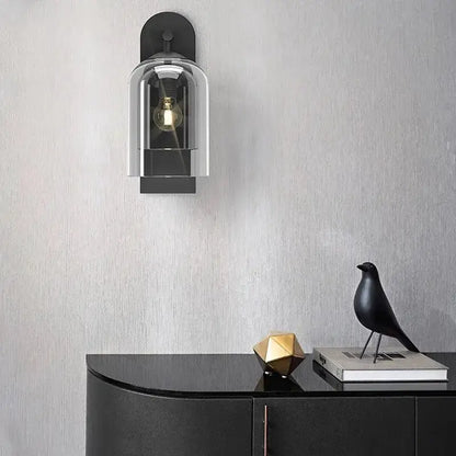 Luxury amber glass wall sconce with clear dome shade and black backplate on Tampa Home & Garden Store