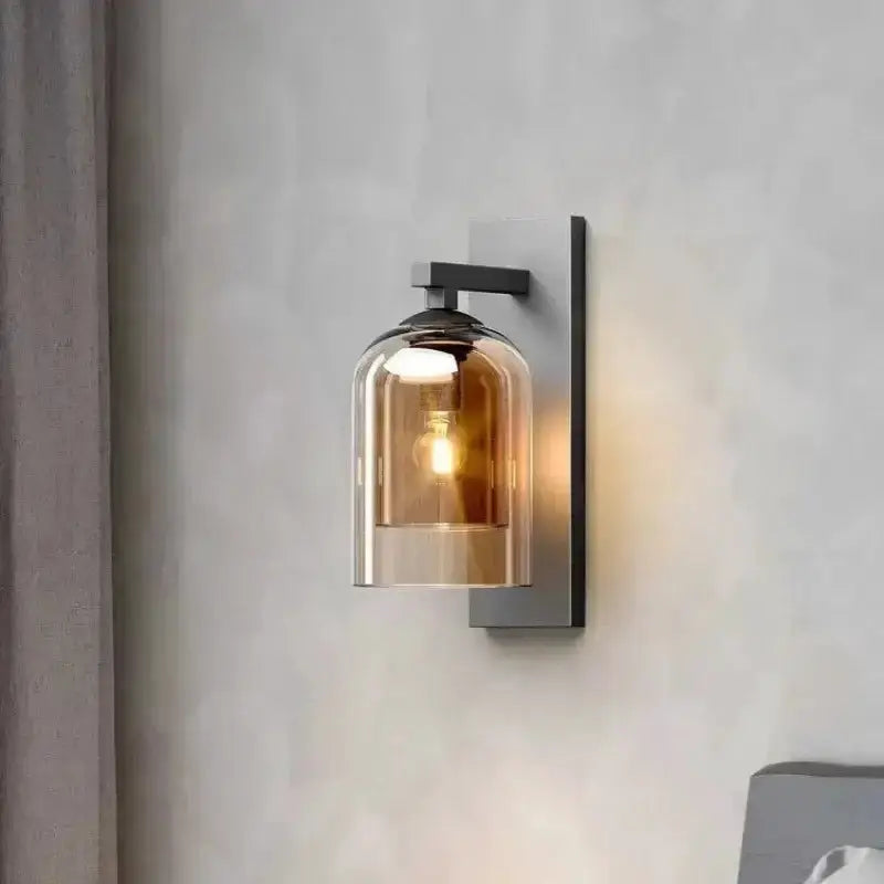 Amber glass wall sconce with black metal backplate and warm glow bulb for bedroom decor on Tampa Home & Garden Store