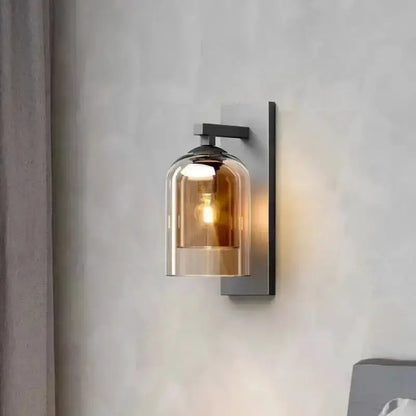 Amber glass wall sconce with black metal backplate and warm glow bulb for bedroom decor on Tampa Home & Garden Store