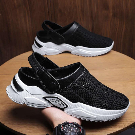 Two black men's mesh slip-on sneakers with white platform soles and Velcro straps on a table on Tampa Home & Garden Store