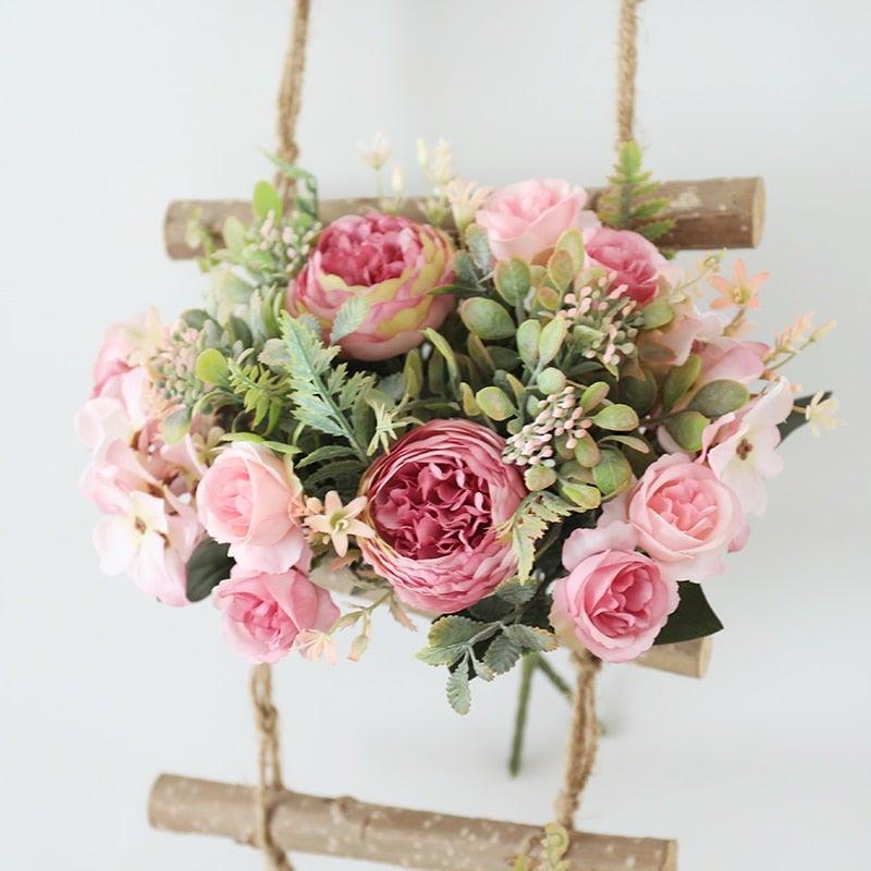 Stevvex artificial silk rose bouquet with pink peonies and greenery on a wooden rope swing on Tampa Home & Garden Store