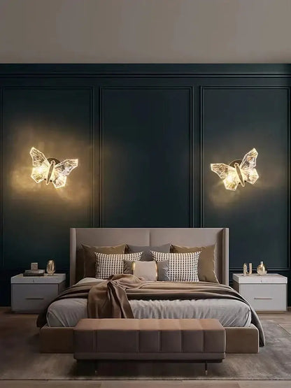 Decorbites gold butterfly Nordic LED wall lamp pair glowing over navy paneled bedroom wall on Tampa Home & Garden Store