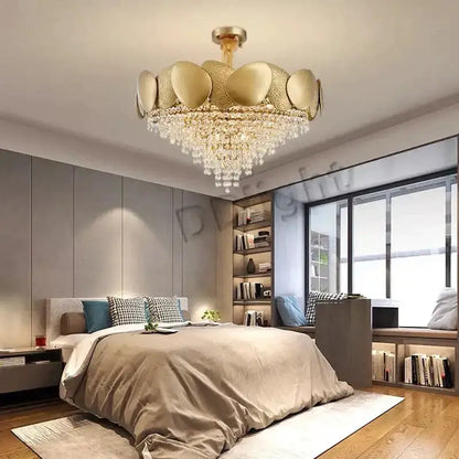 Luxury gold crystal LED ceiling chandelier by Decorbites over a modern bedroom bed on Tampa Home & Garden Store
