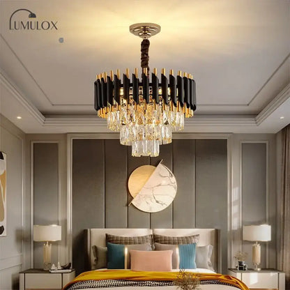 Black crystal tiered chandelier with gold accents hangs from the ceiling above a bedroom on Tampa Home & Garden Store
