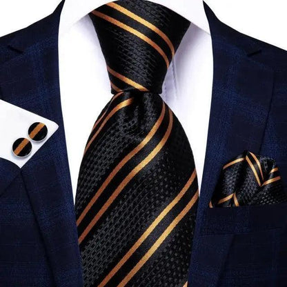 Stevvex silk necktie with matching pocket square and cufflinks in black/gold stripes on navy suit on Tampa Home & Garden Store