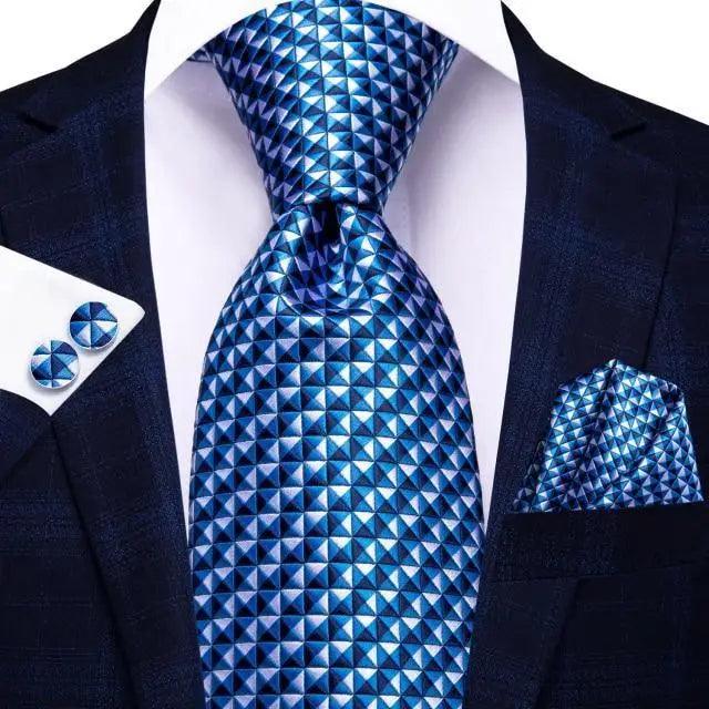 Stevvex silk necktie with blue triangle print; pocket square and cufflinks set on navy suit on Tampa Home & Garden Store