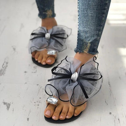Stevvex bow sandals pair with sheer gray bow, rhinestone center, black ribbon trim on Tampa Home & Garden Store