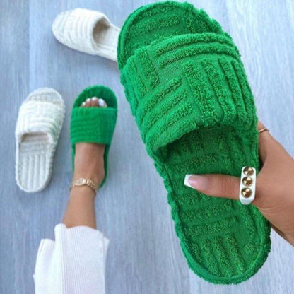 Stevvex green plush memory-foam house slippers; slide-on style with a white pair visible on Tampa Home & Garden Store