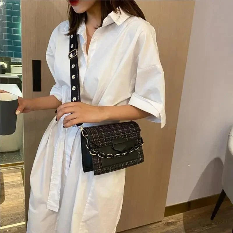 Stevvex black textured shoulder bag with wide chain strap crossbody with white shirt dress on Tampa Home & Garden Store