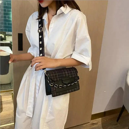 Stevvex black textured shoulder bag with wide chain strap crossbody with white shirt dress on Tampa Home & Garden Store