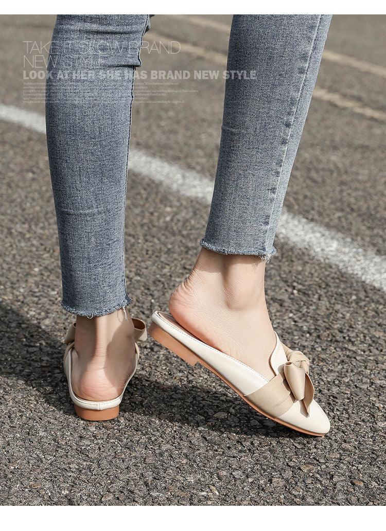 Stevvex beige bow flat mule sandals with open back and rounded toe worn with denim jeans on Tampa Home & Garden Store