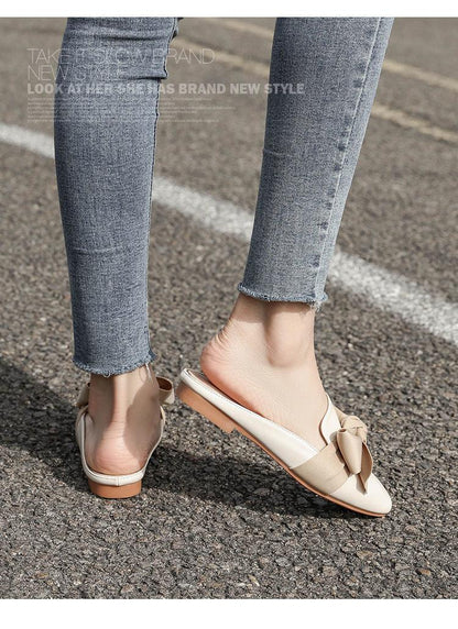 Stevvex beige bow flat mule sandals with open back and rounded toe worn with denim jeans on Tampa Home & Garden Store