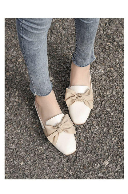 Pair of beige bow-front closed-toe flat slippers with white toe caps, two-tone women's sandals on Tampa Home & Garden Store