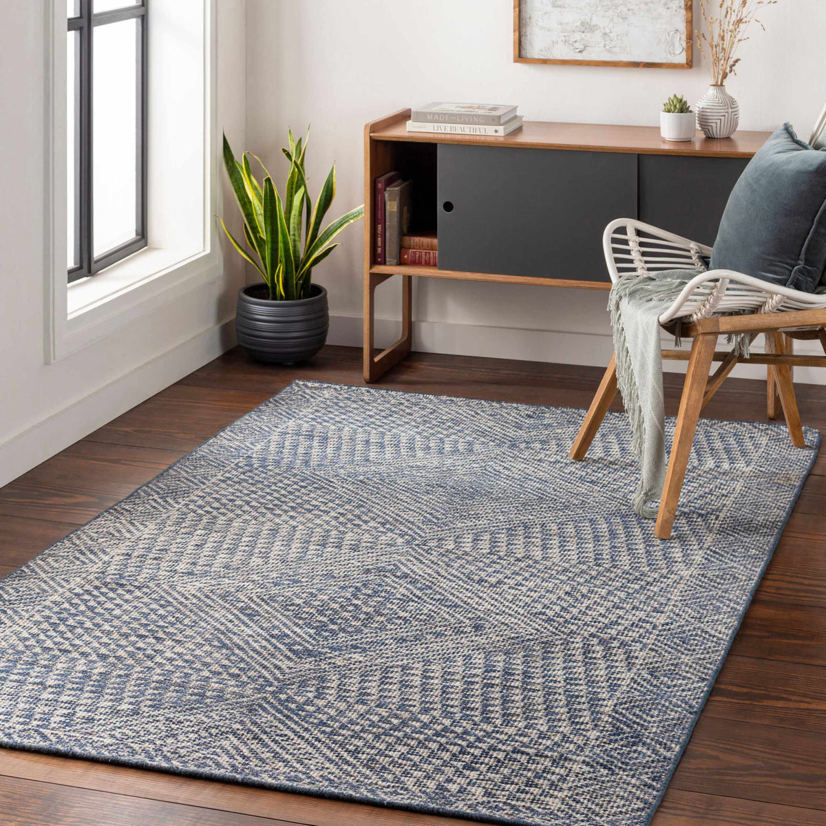 Boutique Rugs Moyne Area Rug blue gray geometric weave on dark wood floor on Tampa Home & Garden Store