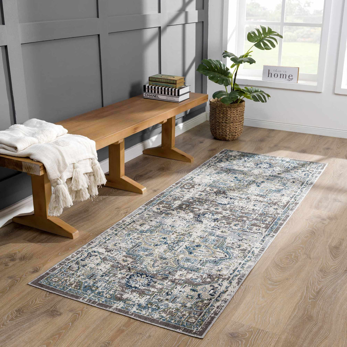 Cabacungan gray and blue washable area rug by Boutique Rugs in a room with bench and plant on Tampa Home & Garden Store