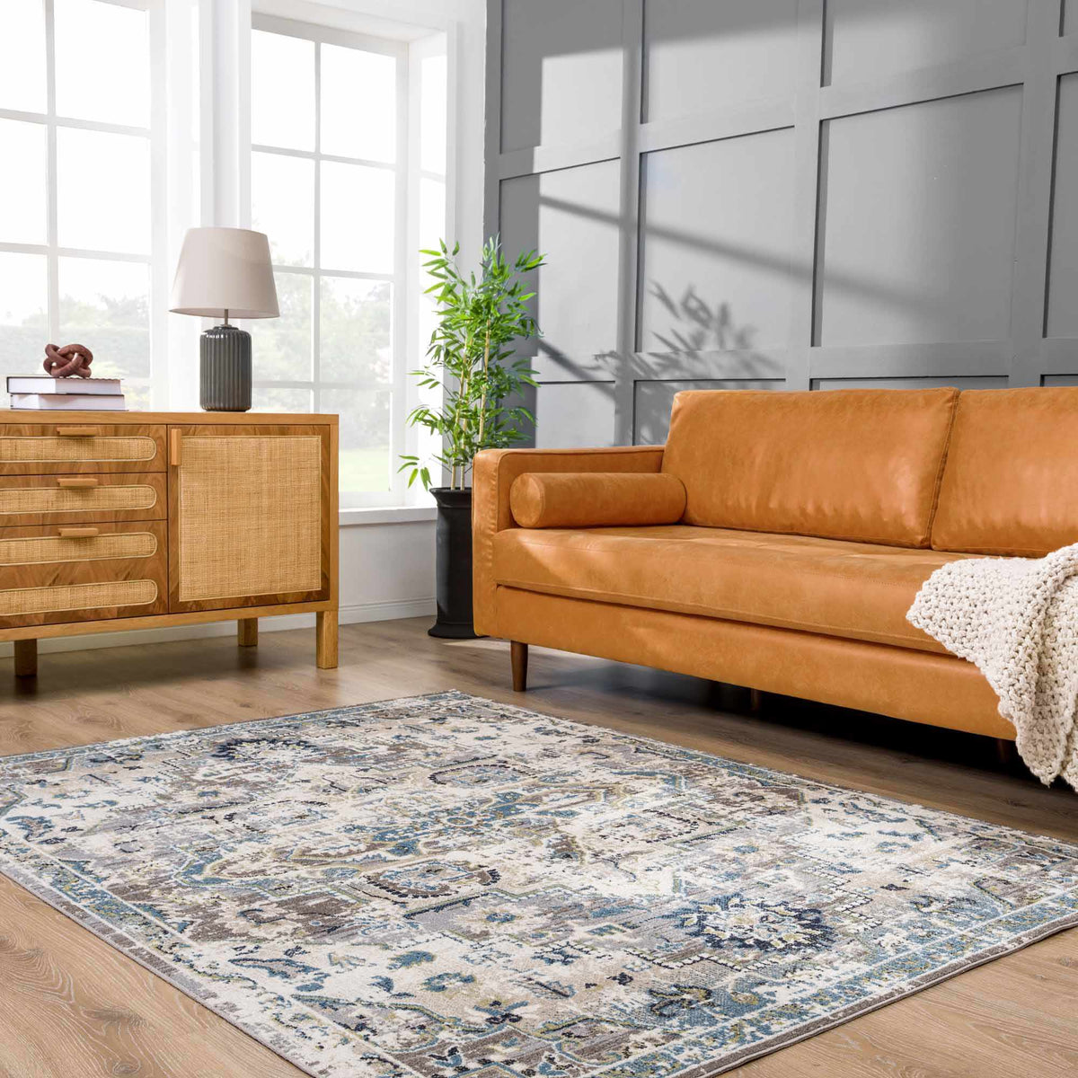 Cabacungan Gray & Blue Washable Area Rug in a modern living room with a tan leather sofa on Tampa Home & Garden Store