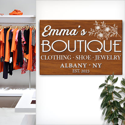 Boutique Sign V canvas by Tailored Canvases on wood-grain panel with white floral motif on Tampa Home & Garden Store