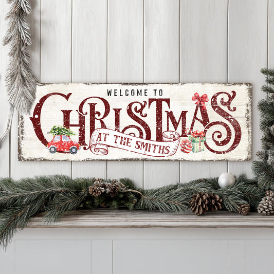 Canvas Family Welcome To Christmas Sign II with red lettering and pine garland on Tampa Home & Garden Store