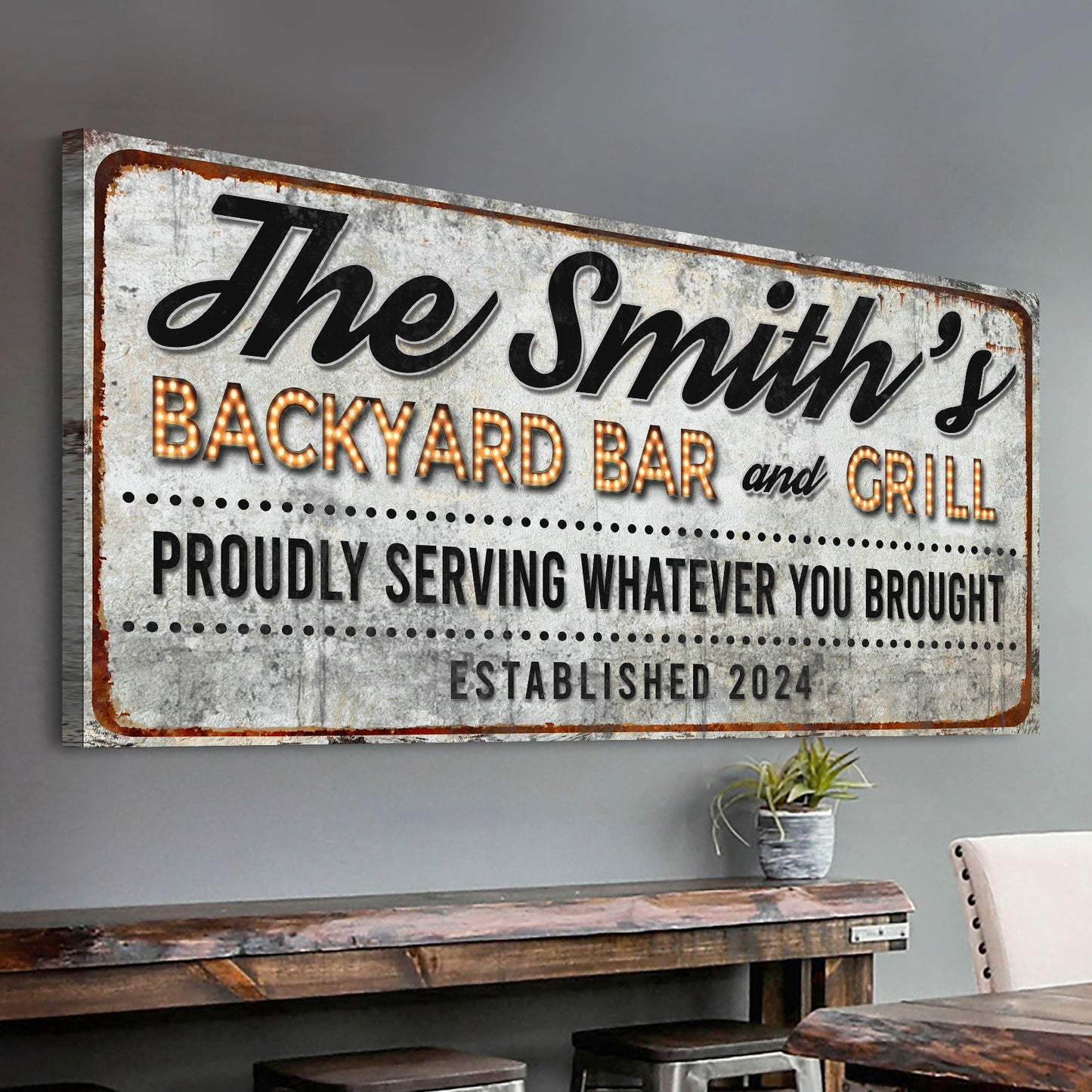 Canvas sign The Smith's Backyard Bar and Grill with rusted edge and illuminated marquee letters on Tampa Home & Garden Store