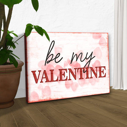Be My Valentine canvas sign by Tailored Canvases with pink hearts, leaning beside a plant on Tampa Home & Garden Store