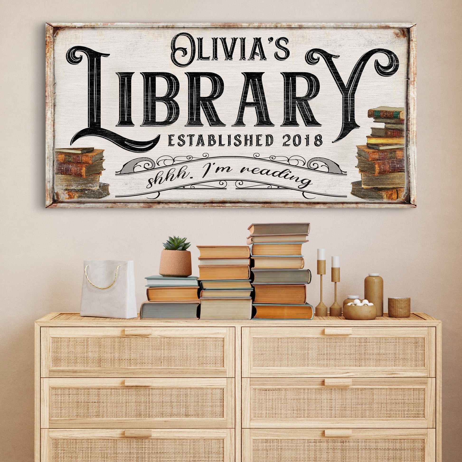 Shhh I'm Reading Library Sign Canvas wall art with vintage black typography and rustic frame stacks of books on sides on Tampa Home & Garden Store