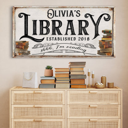 Shhh I'm Reading Library Sign Canvas wall art with vintage black typography and rustic frame stacks of books on sides on Tampa Home & Garden Store