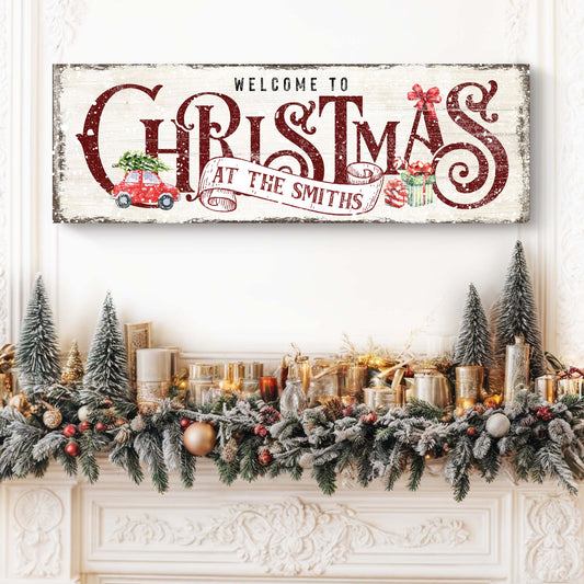 Family Welcome To Christmas Sign II canvas with distressed whitewash and bold red lettering, holiday garland on mantel on Tampa Home & Garden Store