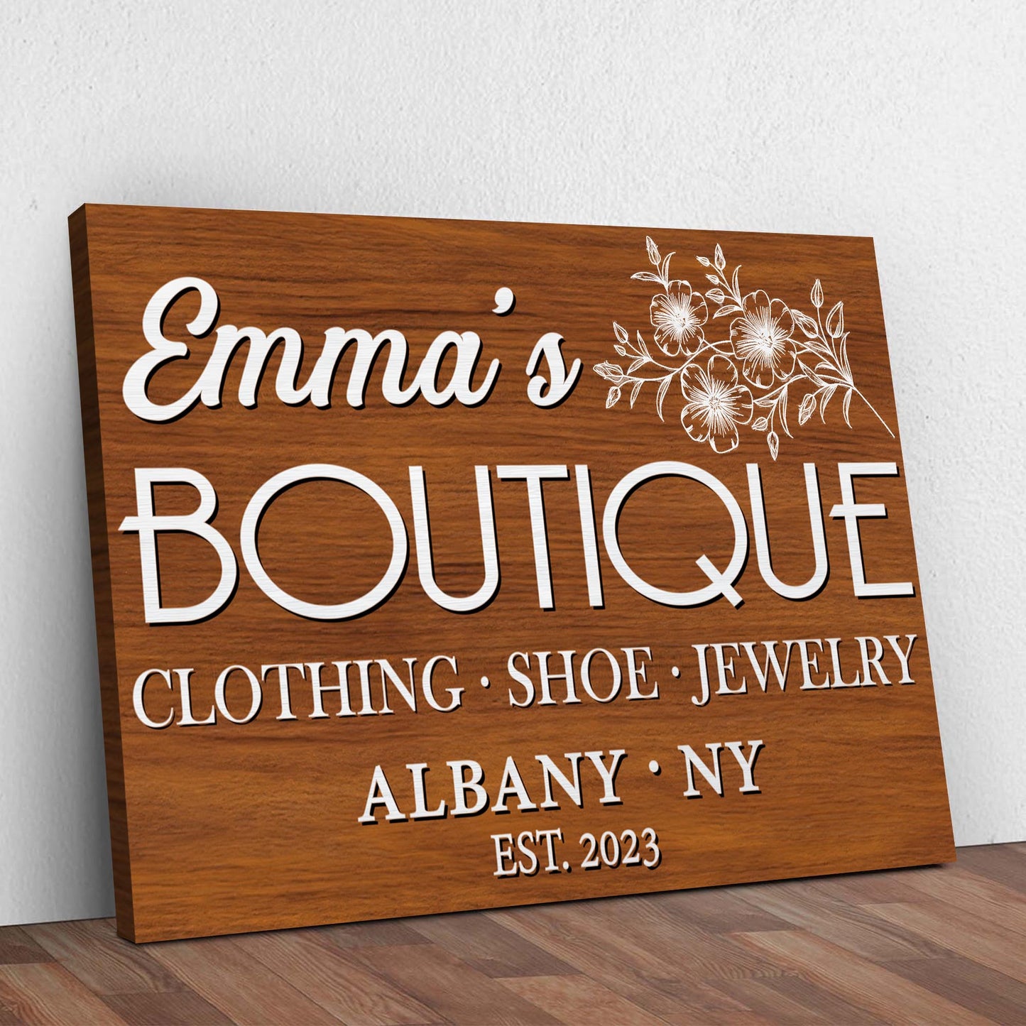 Boutique Sign V canvas with white script Emma's and floral accents on wood grain on Tampa Home & Garden Store