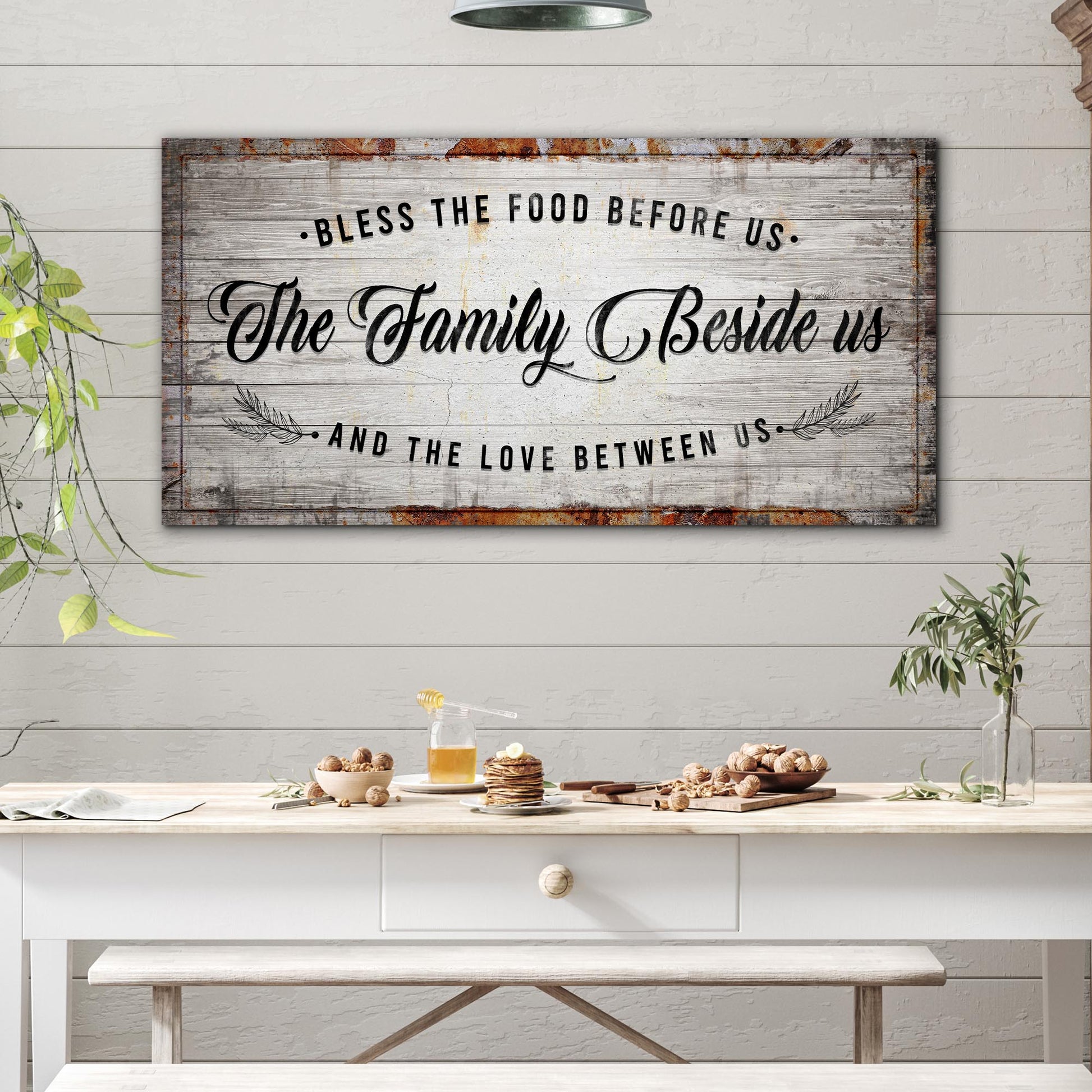 Bless The Food Before Us canvas sign with rustic weathered wood, black script typography on Tampa Home & Garden Store