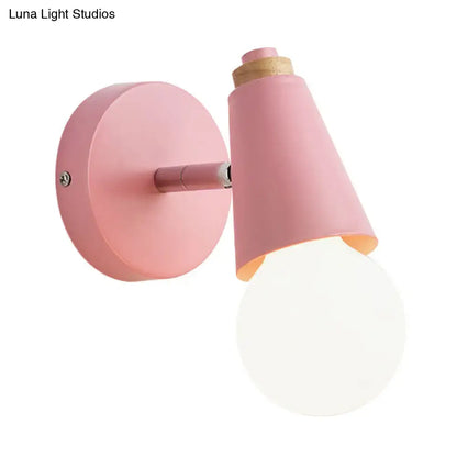 Pink cone wall sconce by Decorbites with round backplate and angled shade wall-mounted on Tampa Home & Garden Store