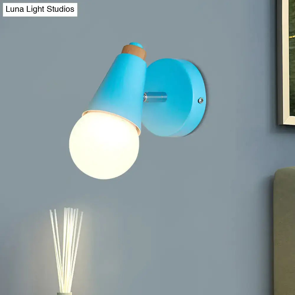 Decorbites blue cone wall sconce with round backplate and frosted globe bulb on blue wall on Tampa Home & Garden Store