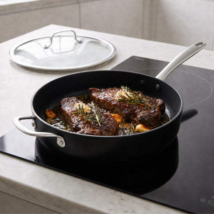 Ceramic nonstick cookware set in black with glass lid and stainless handles on stovetop on Tampa Home & Garden Store