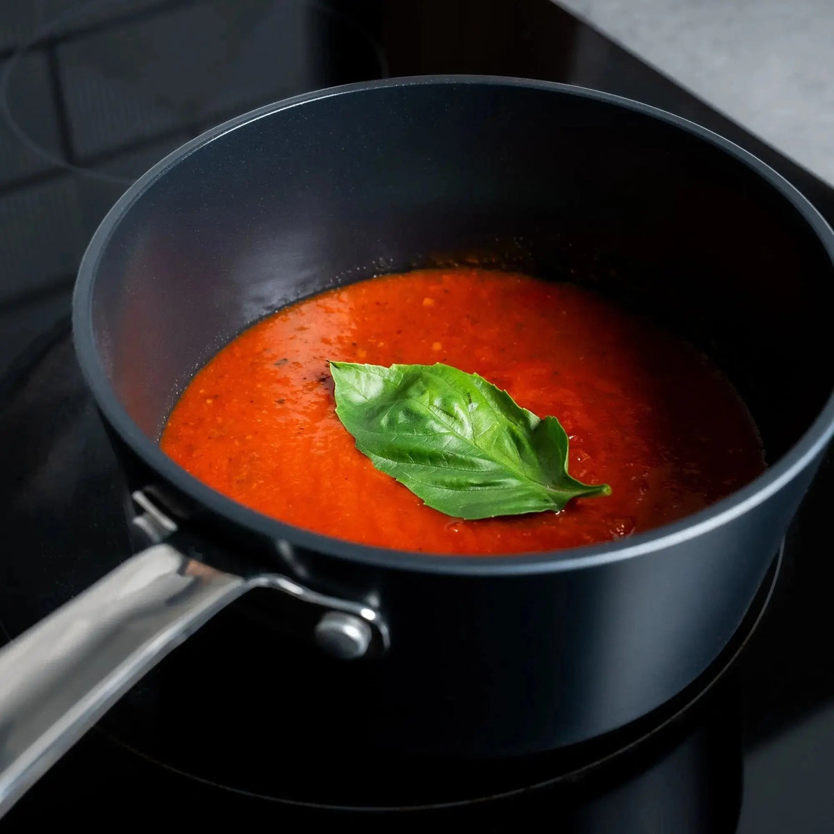 Alva Ceramic Nonstick Saucepan 2-Qt with red tomato sauce and fresh basil on Tampa Home & Garden Store