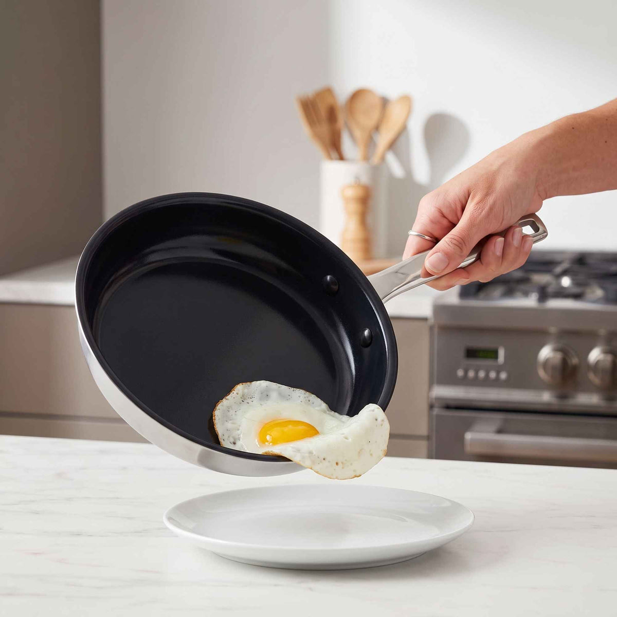 5-Ply Nonstick Ceramic Frying Pan by Alva Cookware stainless handle cooking a fried egg on Tampa Home & Garden Store