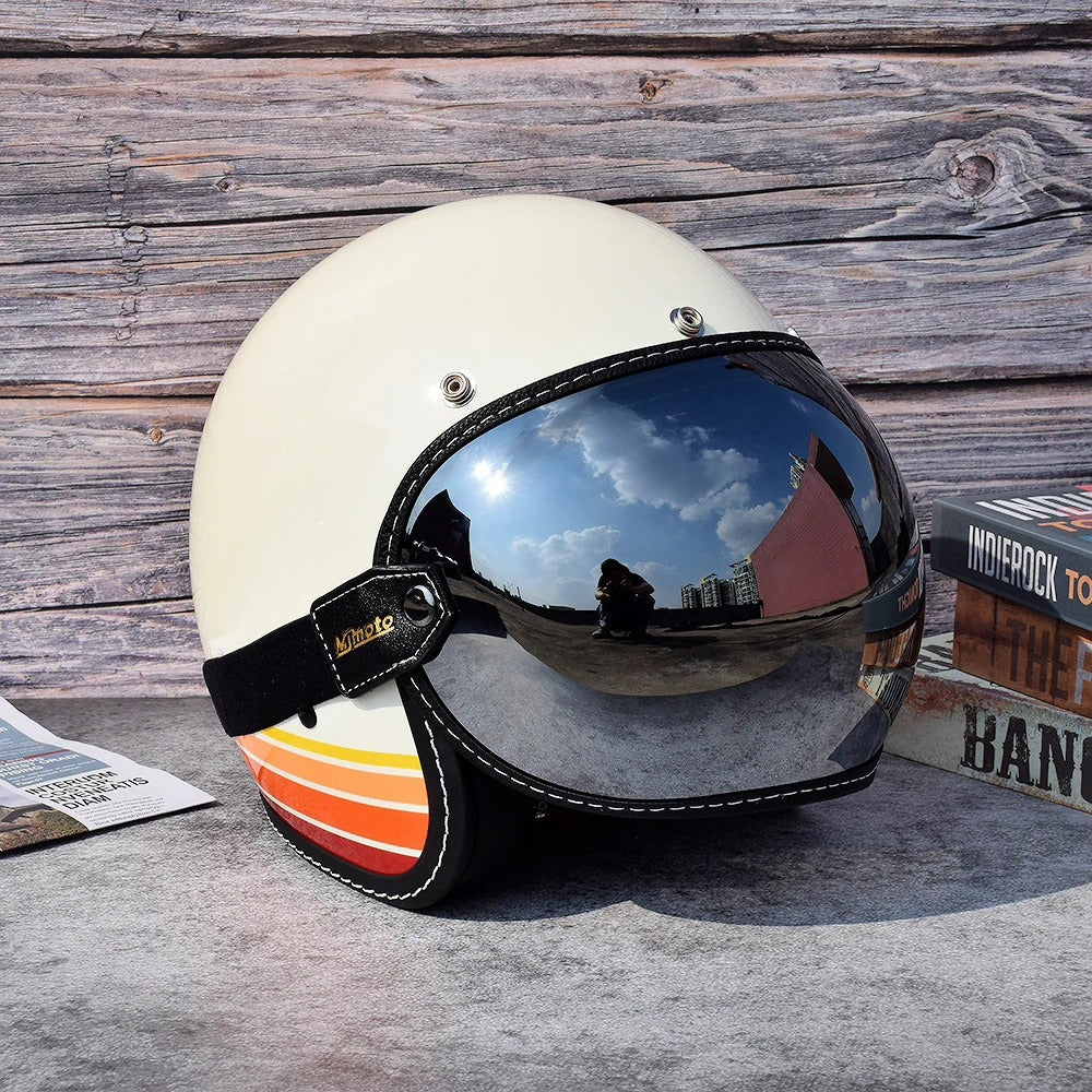 Motorcycle helmet in white with mirrored visor and black strap against a wooden backdrop on Tampa Home & Garden Store