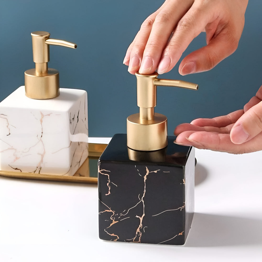 Two Moktan Sabai marble ceramic soap dispensers with gold pumps, black and white marble blocks on Tampa Home & Garden Store