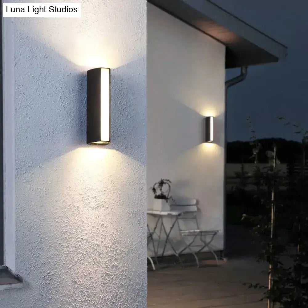 Matte black rectangle outdoor wall light dual directional LED sconce on white exterior wall on Tampa Home & Garden Store