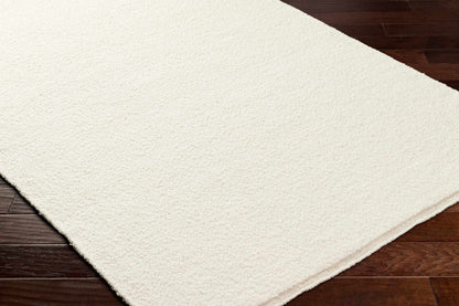 Niabi Area Rug by Boutique Rugs, cream shag texture on dark wood floor on Tampa Home & Garden Store