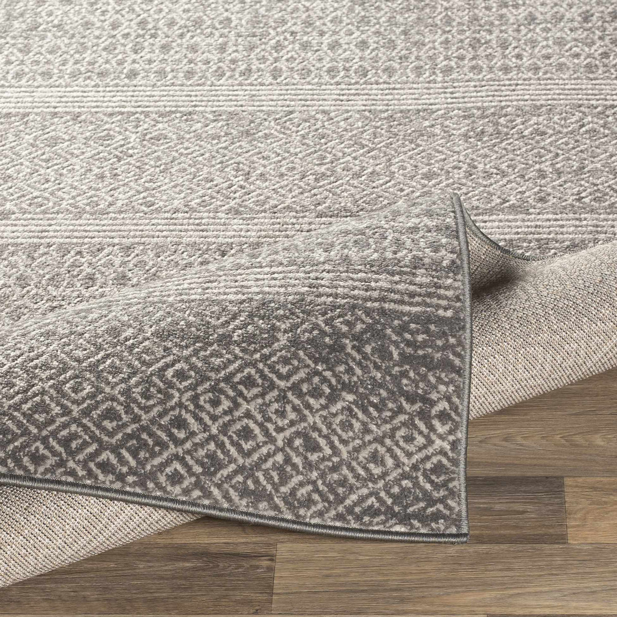 Mckinney Area Rug - Clearance by Boutique Rugs in gray textured pattern on hardwood floor on Tampa Home & Garden Store
